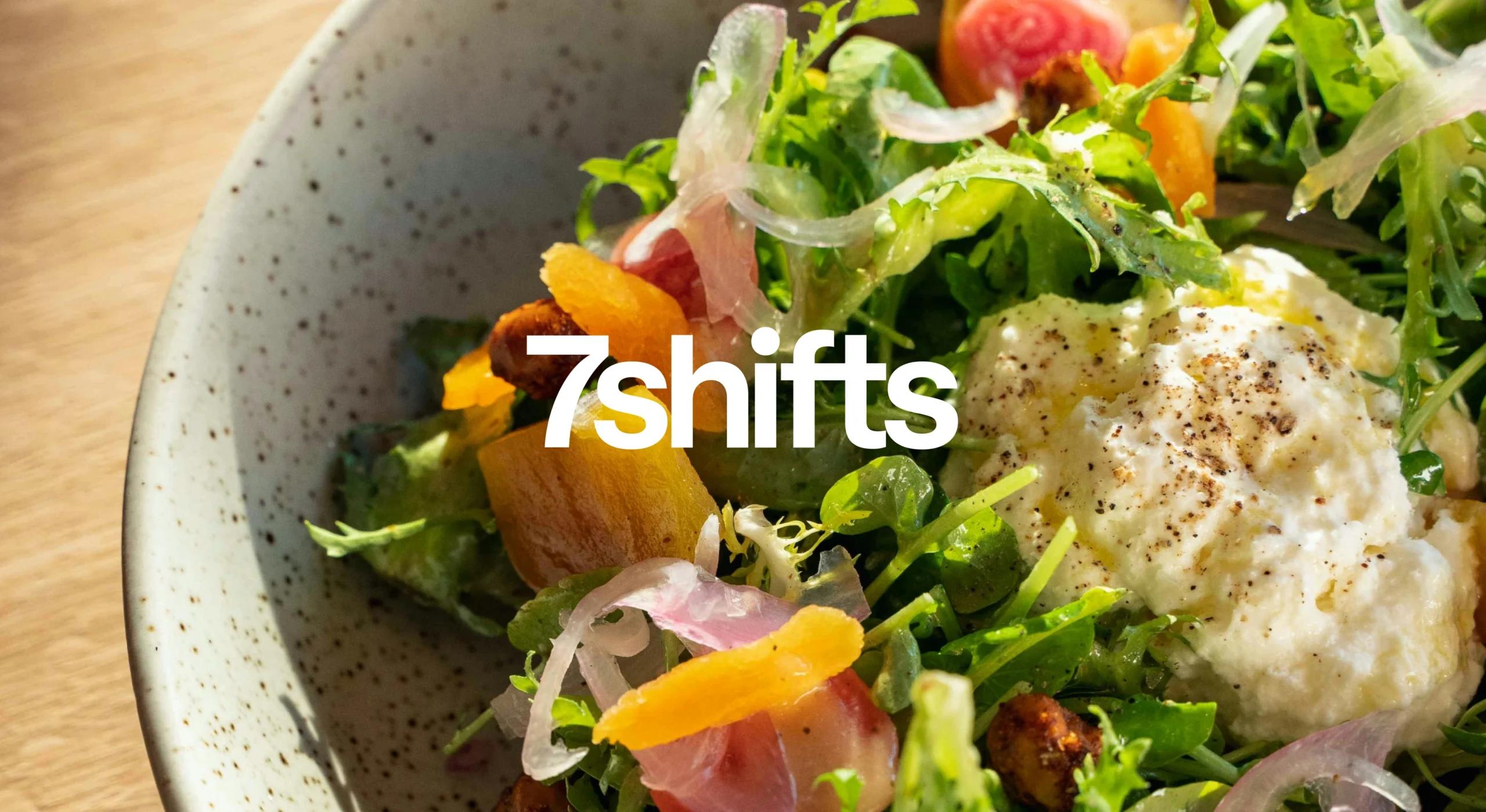 A bowl of fresh green salad with fried egg.